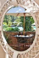 a reflection of a table and chairs in a mirror at Valley Lodge & Spa in Magaliesburg