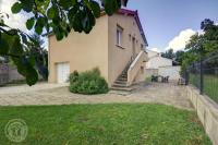 a house with a staircase leading up to a building at Le sorberan in Sorbiers