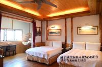 a bedroom with two beds and a ceiling fan at Cingjing Vienna Pleasance Cottage in Ren&#39;ai