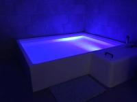 a white bath tub with a blue light in a room at Little California - Adorable Studio Indépendant in Cagnes-sur-Mer