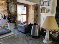 a kitchen with a table with a lamp and a blender at Gîte Maison Maitri in Forgès