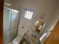 a bathroom with a toilet and a sink and a mirror at Chico de Sá Pousada in Pirenópolis