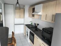 a kitchen with a sink and a dishwasher at Spacieux et joli appartement de 2 à 4 personnes • Parking • Wifi in Fenouillet