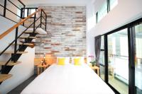 a bedroom with a bed and a brick wall at Qixingtan Xinghai B&amp;B in Dahan