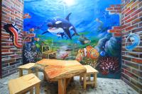 a dining room with a mural of a shark at Qixingtan Xinghai B&amp;B in Dahan