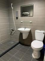 a bathroom with a toilet and a sink at Long Siang Hotel in Kaohsiung