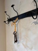 a pair of scissors hanging on a wall at Maison Marie in Lagarde