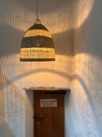 a pendant light hanging over a door in a building at Maison Marie in Lagarde