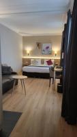 a bedroom with a bed and a couch and a table at Magda Champs Elysées in Paris