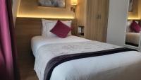 a bedroom with a large white bed with red pillows at Magda Champs Elysées in Paris