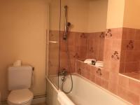 a bathroom with a tub and a toilet and a shower at Logis Hôtel-Restaurant Les Airelles in Neufchâtel-en-Bray