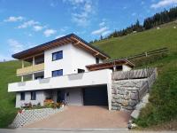 a white house on a hill with a garage at Much`s Bergstüberl in Wattenberg