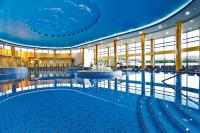 a large pool with a fountain in the middle of a building at A Hoteli - Hotel Izvor in Arandjelovac