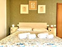 A bed or beds in a room at SIXTIES SUN & SEA MONTEROSSO