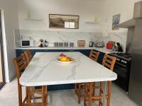 a kitchen with a table with a bowl of fruit on it at Maison de 2 chambres avec piscine privee jardin amenage et wifi a Bruniquel in Bruniquel