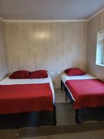 two beds in a room with red and white sheets at STUDIO ENTRE PARIS et DISNEY 3 in Torcy