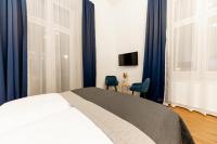 Posteľ alebo postele v izbe v ubytovaní Adagio Downtown Rooms