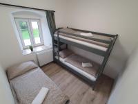 Postel nebo postele na pokoji v ubytování Apartmány ČERNÝ KOHOUT