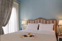 Łóżko lub łóżka w pokoju w obiekcie Ionia Suites