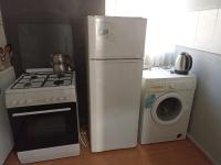 a kitchen with a stove and a refrigerator and a washing machine at EVA GOLD APART in Antalya