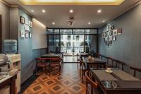 un ristorante con tavoli e sedie in una stanza di Lefoyer Hotel a Hanoi