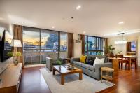 a living room with a couch and a table at Bandara Suites Silom, Bangkok in Bangkok