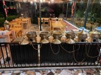 a group of silver tea pots on a table at Sangita Resorts in Nainital