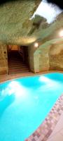 a swimming pool with blue water in a cave at Ta Majsi farmhouse with indoor heated pool in San Lawrenz