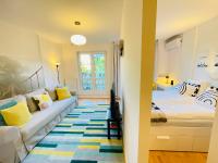 A bed or beds in a room at Peony Holló Apartment - Free Garage under the house