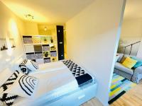 A bed or beds in a room at Peony Holló Apartment - Free Garage under the house