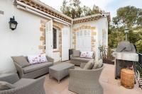 a patio with couches and chairs and a fireplace at VILLA LE MAS D&#39;AZUR BY ESTATESCANNES in Vallauris