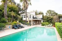 a house with a swimming pool in front of a house at VILLA LE MAS D&#39;AZUR BY ESTATESCANNES in Vallauris