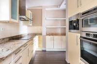 a kitchen with white cabinets and stainless steel appliances at VILLA LE MAS D&#39;AZUR BY ESTATESCANNES in Vallauris