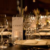 a table with plates and wine glasses on it at Castlemartyr Resort Hotel in Castlemartyr