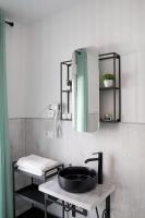 a bathroom with a black sink and a mirror at Casa Rural Las Cuevas de Setenil in Setenil