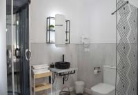 a bathroom with a sink and a toilet and a shower at Casa Rural Las Cuevas de Setenil in Setenil