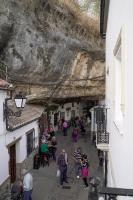 a group of people walking down a street at Casa Rural Las Cuevas de Setenil in Setenil