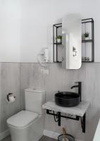 a bathroom with a sink and a toilet at Casa Rural Las Cuevas de Setenil in Setenil