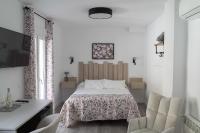a bedroom with a bed and a table and chairs at Casa Rural Las Cuevas de Setenil in Setenil