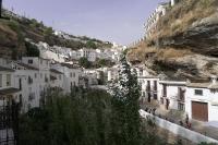 a group of white buildings on a mountain at Casa Rural Las Cuevas de Setenil in Setenil