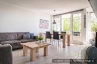 a living room with a couch and a table at Residentie Californië in De Koog
