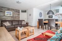 a living room with a couch and a table at Residentie Californië in De Koog