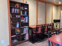 a library with a table and chairs and books at Kyoto Inn Gion The Second in Kyoto