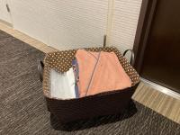 a suitcase filled with clothes sitting on a floor at Kyoto Inn Gion The Second in Kyoto