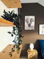 a room with a plant hanging from a stair case at Cosy 2-Bedroom Apartment in the center of Hotton in Hotton