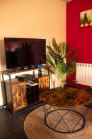 a living room with a tv and a coffee table at Cosy 2-Bedroom Apartment in the center of Hotton in Hotton