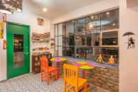 a room with a table and chairs in front of a store at THE CEDAR CASTLE in Mukteswar