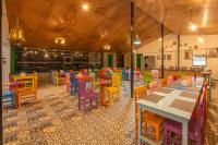 a dining room with colorful tables and chairs at THE CEDAR CASTLE in Mukteswar