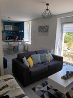 a living room with a couch and a table at Studio entre Clohars Carnoet et Doelan in Clohars-Carnoët