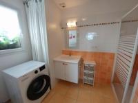 a bathroom with a washing machine and a sink at Holiday home with sea views, Plounéour-Brignogan-Plages in Plounéour-Trez